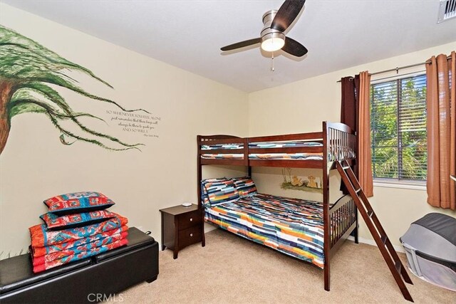 bedroom with ceiling fan and light colored carpet