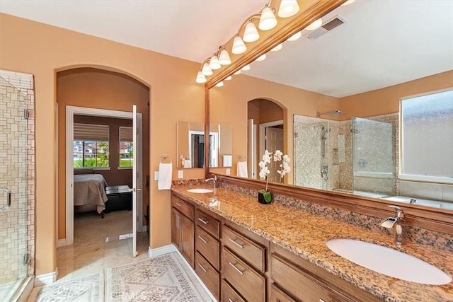 bathroom with tile patterned flooring, vanity, and a shower with door