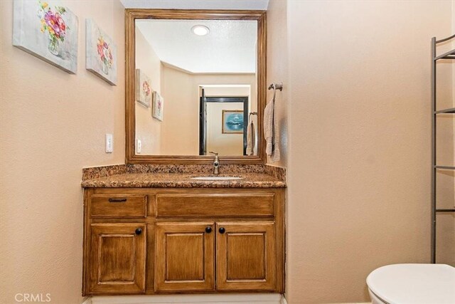 bathroom with vanity and toilet