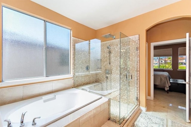 bathroom featuring tile patterned flooring and separate shower and tub