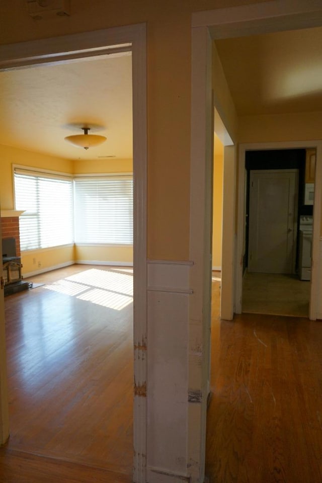 corridor with hardwood / wood-style floors