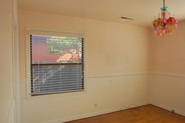 unfurnished room with wood-type flooring