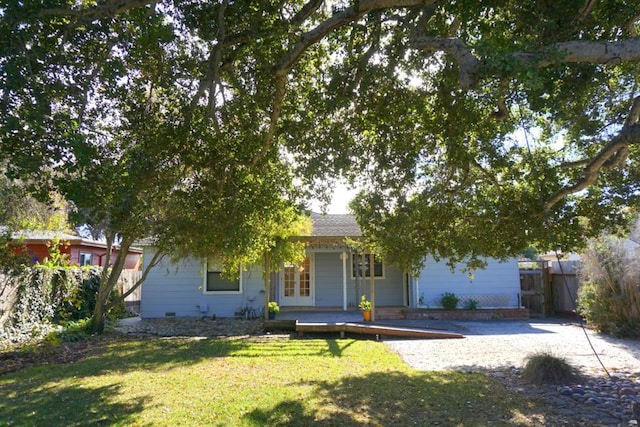 obstructed view of property with a front lawn