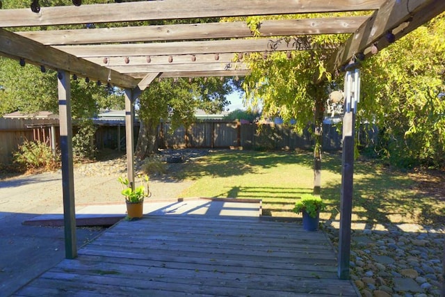 wooden deck with a yard and a pergola