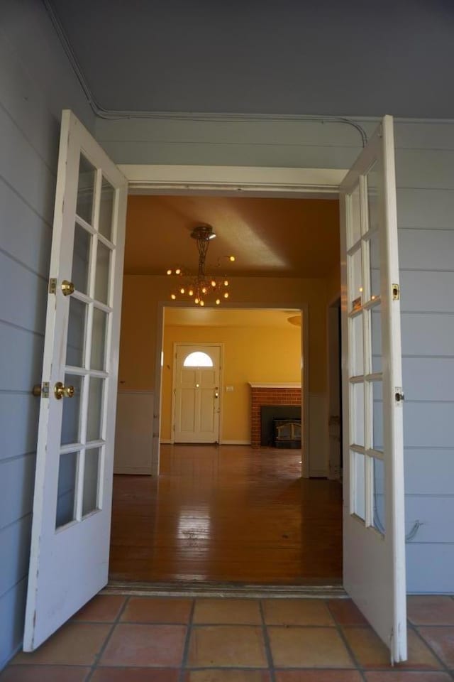 interior space featuring tile patterned flooring, a fireplace, and french doors