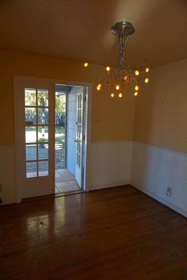 interior space with french doors, an inviting chandelier, and hardwood / wood-style flooring