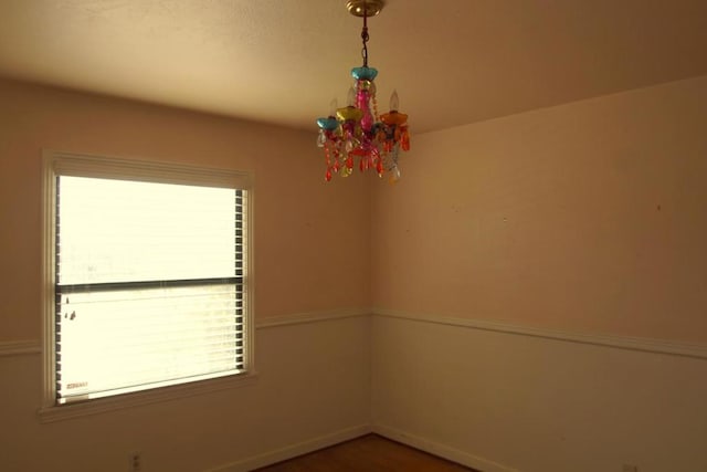 empty room with a notable chandelier