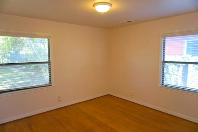 empty room with hardwood / wood-style flooring