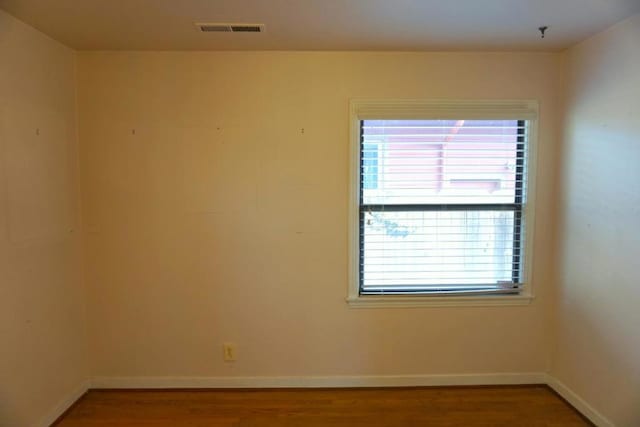 unfurnished room featuring hardwood / wood-style flooring