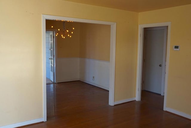 empty room with dark hardwood / wood-style flooring