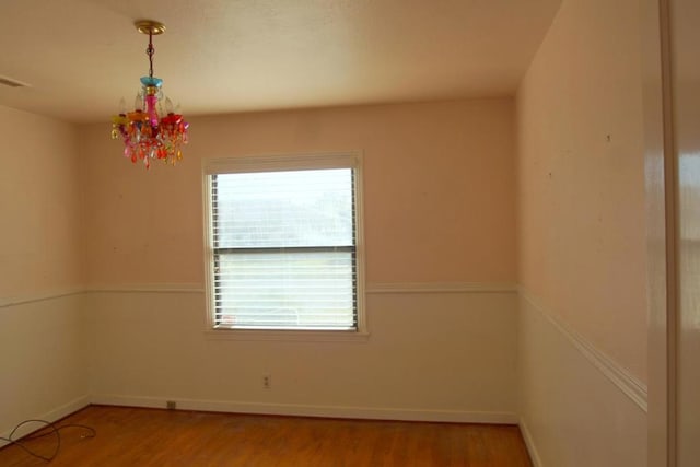 spare room featuring wood-type flooring