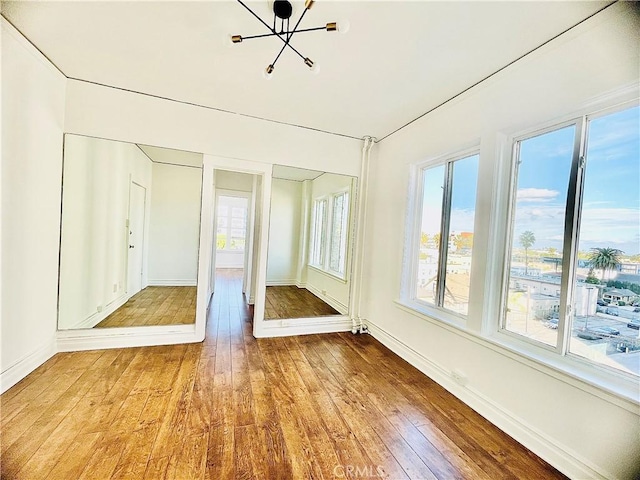 unfurnished sunroom featuring an inviting chandelier