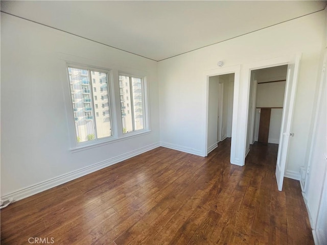 unfurnished room with dark hardwood / wood-style floors