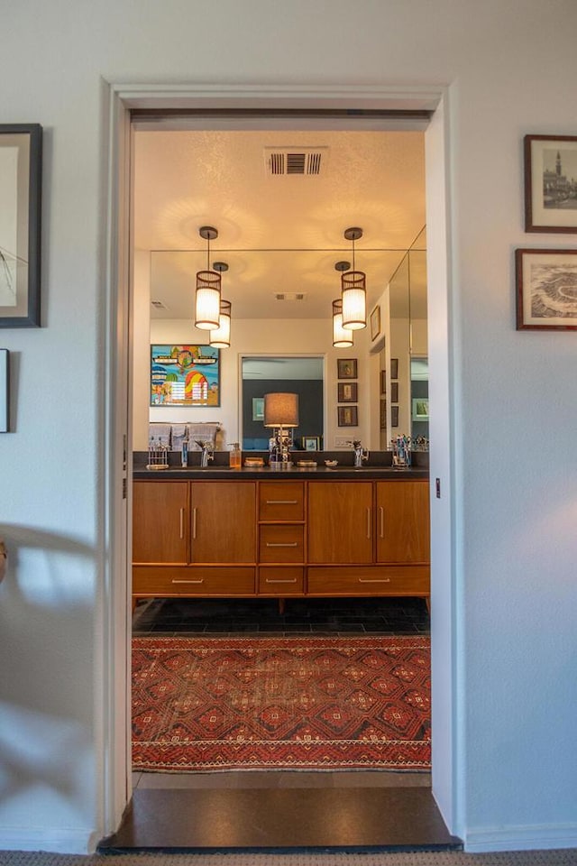 bar with hanging light fixtures