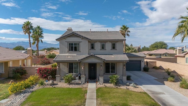 front facade featuring a garage and a front yard