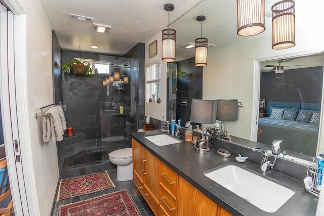 bathroom with walk in shower, vanity, toilet, and a textured ceiling