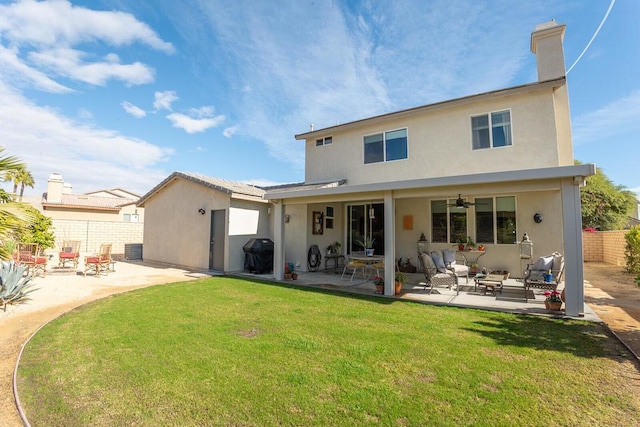 rear view of house with a patio area and a lawn