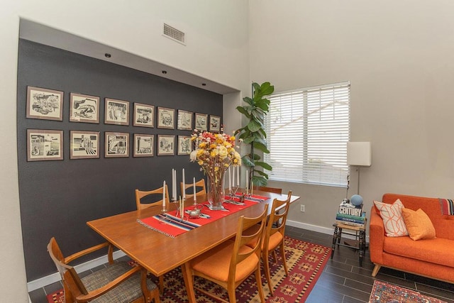 dining area with a towering ceiling