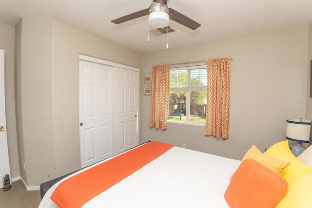 bedroom featuring carpet floors, ceiling fan, and a closet