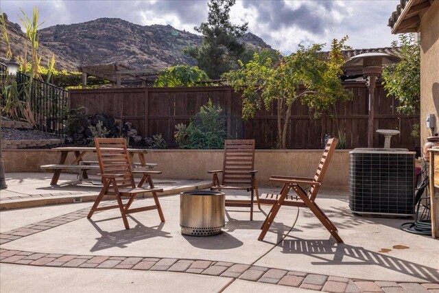 view of patio / terrace featuring a mountain view and cooling unit