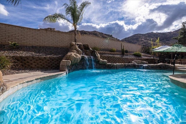 view of pool featuring pool water feature and a mountain view