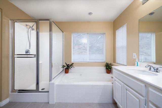 bathroom with tile patterned floors, vanity, and plus walk in shower