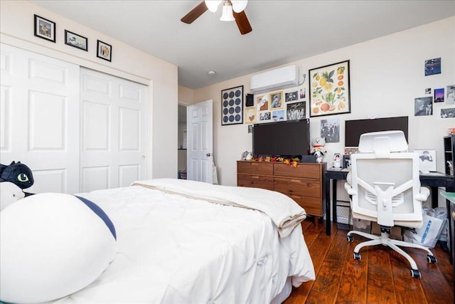 bedroom featuring a wall unit AC, dark hardwood / wood-style flooring, ceiling fan, and a closet