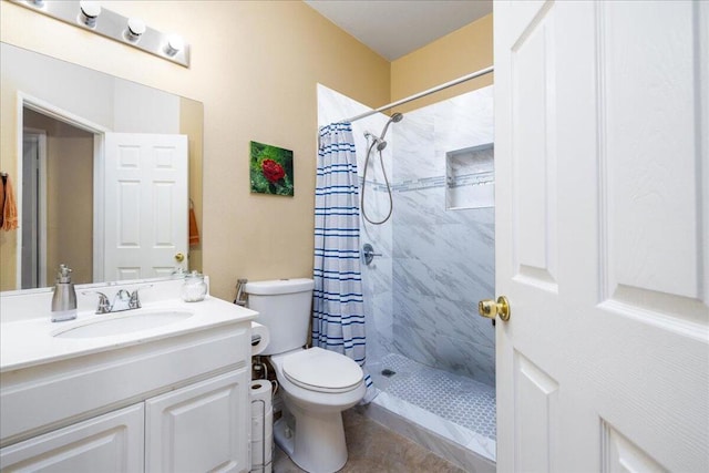 bathroom featuring tile patterned floors, a shower with curtain, toilet, and vanity