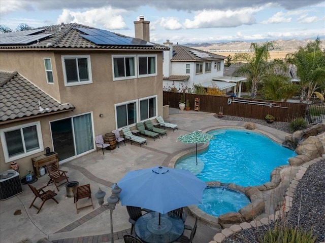 view of pool featuring a mountain view, a patio, and central AC unit