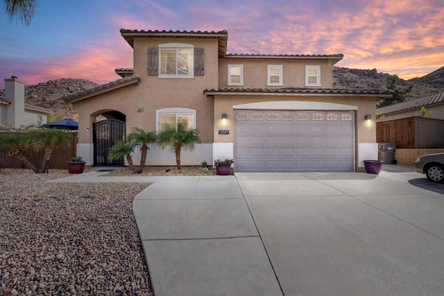 mediterranean / spanish-style house with a garage