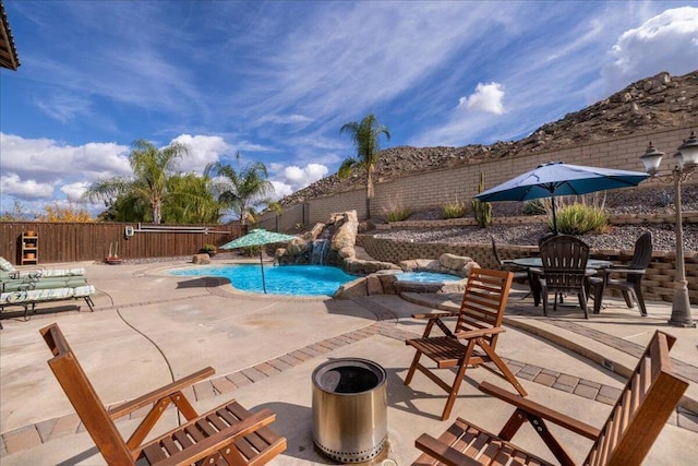 view of swimming pool featuring a fire pit, a patio, and pool water feature