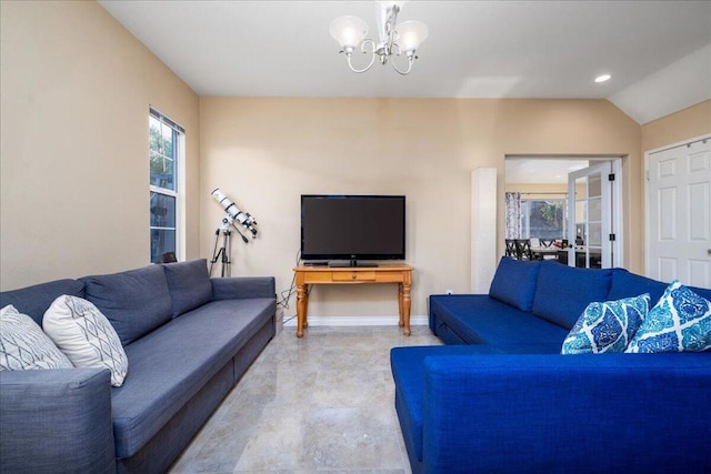 living room with lofted ceiling and an inviting chandelier