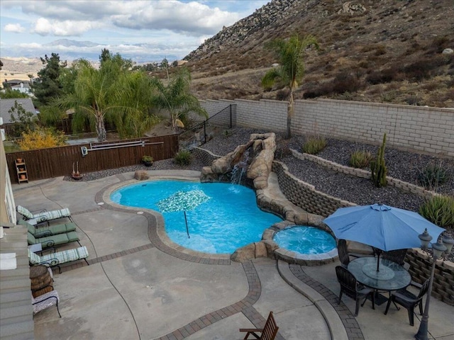 view of pool featuring a mountain view and a patio