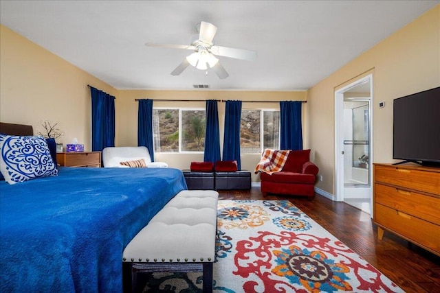 bedroom featuring connected bathroom, dark hardwood / wood-style floors, and ceiling fan