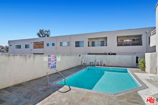 view of swimming pool featuring a patio area