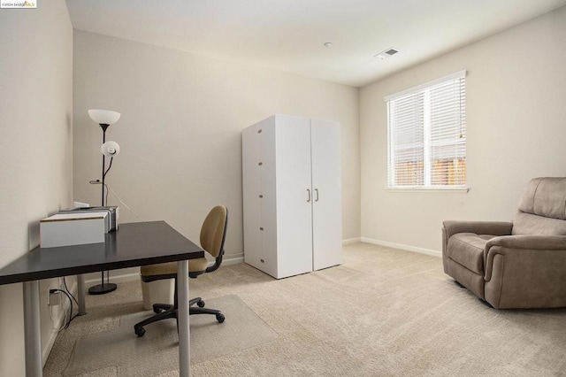 office area featuring light carpet