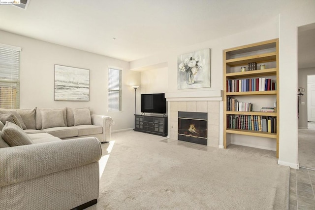 carpeted living room with built in features and a fireplace