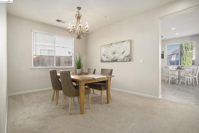 carpeted dining space with a notable chandelier and a wealth of natural light