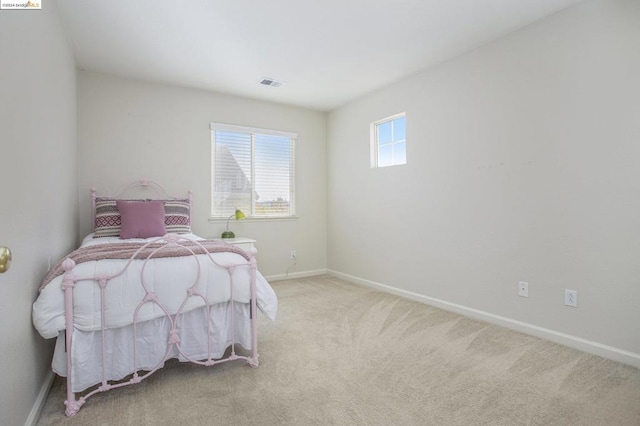 bedroom featuring light colored carpet