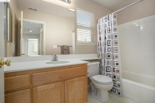 full bathroom with shower / tub combo with curtain, vanity, tile patterned floors, and toilet