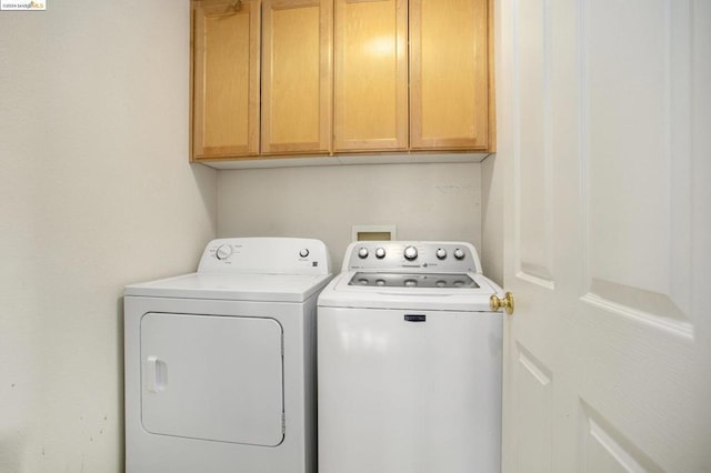 laundry room with cabinets and washer and dryer