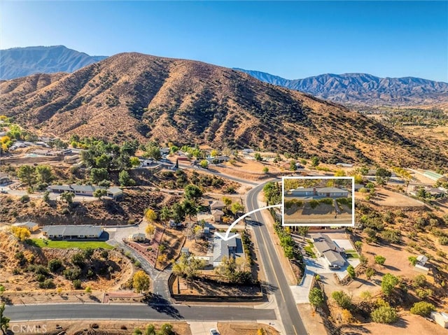 birds eye view of property with a mountain view