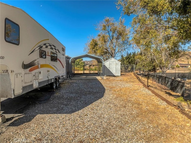 view of yard with a shed and a carport