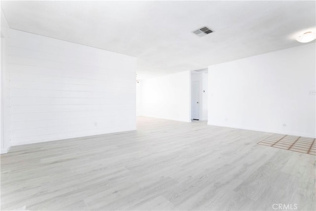 empty room with light hardwood / wood-style floors