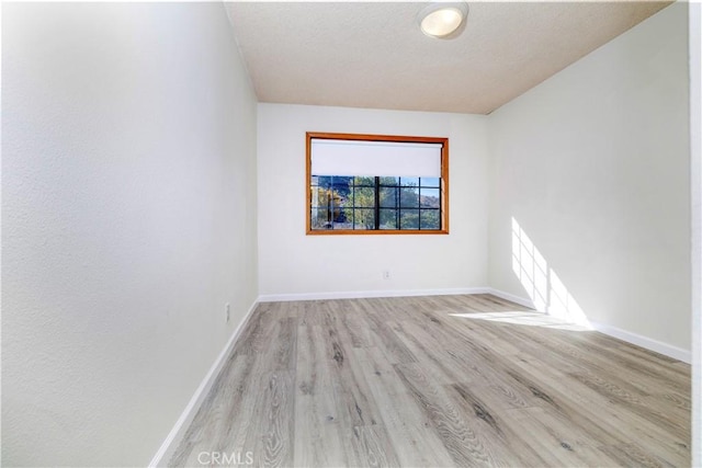 spare room with light hardwood / wood-style floors