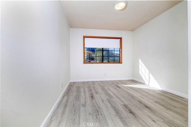 spare room featuring light wood-type flooring