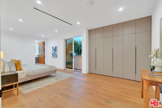 bedroom featuring access to exterior and light hardwood / wood-style floors