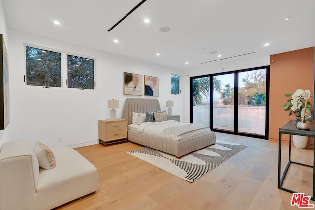 bedroom featuring access to outside and light wood-type flooring