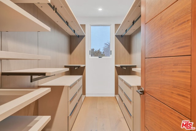 spacious closet with light hardwood / wood-style floors