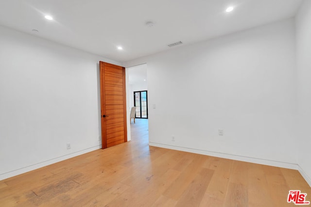 spare room with light wood-type flooring